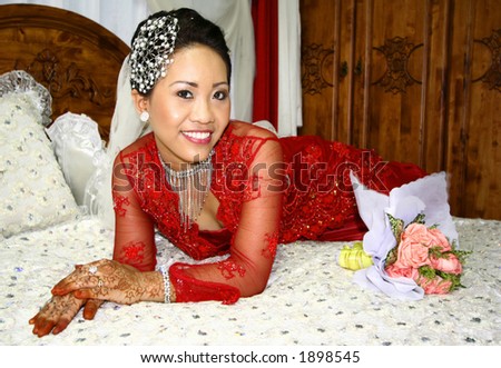 A Malay bride in her red traditional costume as part of the cultural Malay wedding.