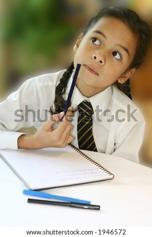 A young girl student thinking hard as she attempts at her homework.
