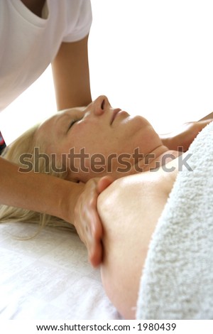 A masseur treating her client with holistic massage