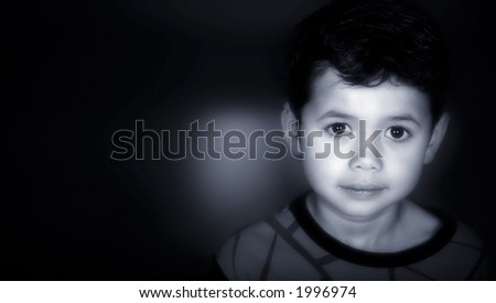 A young boy rendered tri tone of black , blue and white with copyspace