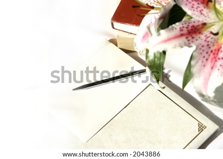 A writing set comprising of reference books, journal and a vase of stargazer lilies, with copyspace.