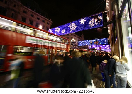 Crowds doing their festive shopping at a very busy Oxford Circus, central London, showing movement blur.