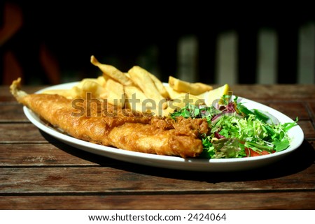 A plate of battered traditional fish and chips. Good old English pub food.
