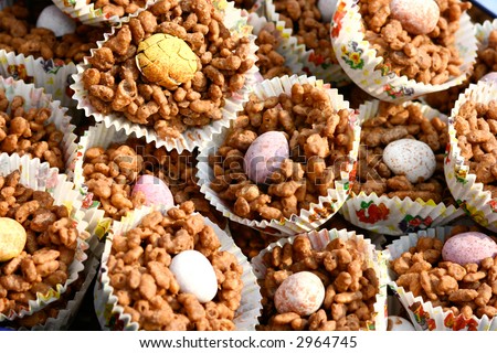 Plate of chocolate covered rice crispies with individual chocolate egg, serve for easter.