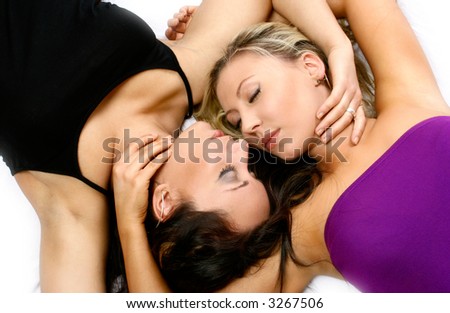 Two beautiful woman, lying head to head, on white background.
