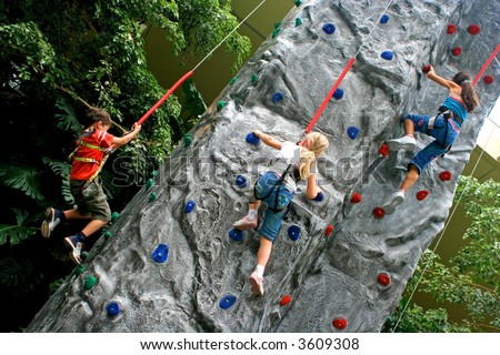 stock photo Young children doing rock climbing in an indoor sports center