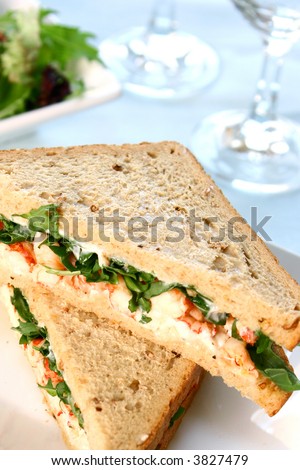 Crayfish and prawn sandwich with mayonaise and fresh rocket leaves on brown bread.