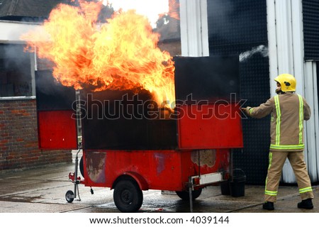 Live demonstration of a simulated kitchen fire done by a fireman dousing a bowl of water on extremely hot pan showing how it catches fire instantly.