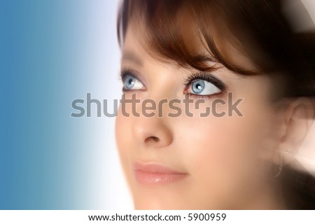 Beautiful woman with blue eyes looking up, image rendered with soft effect to enhance the eye.