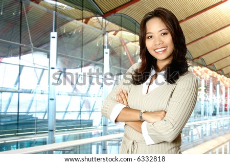 Happy Asian businesswoman in modern corporate building.