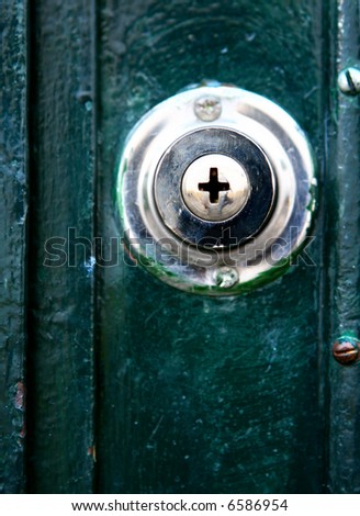 Door knob on old wooden door with unique keyhold.