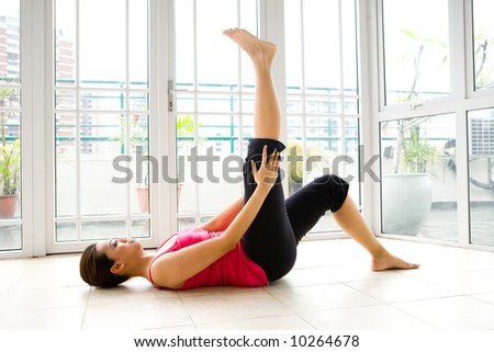 Young woman doing her stretching exercise as part of fitness and healthy living lifestyle.