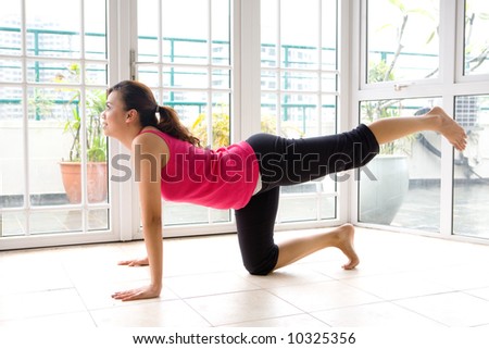 Young female doing her leg stretch as part of fitness and healthy living