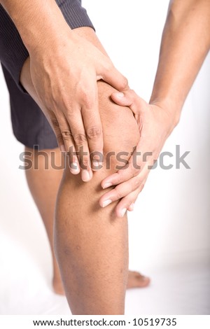 Man with both palm around knee cap to show pain and injury on knee area.