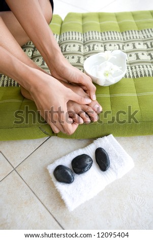 Female self massaging her toes and foot.