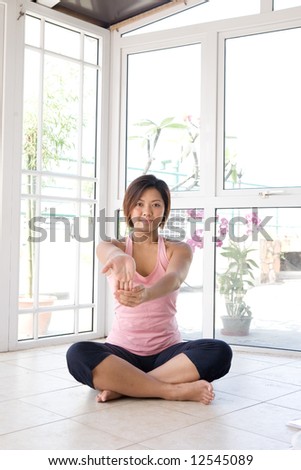 Young female flexing her fingers as part of stretching exercise