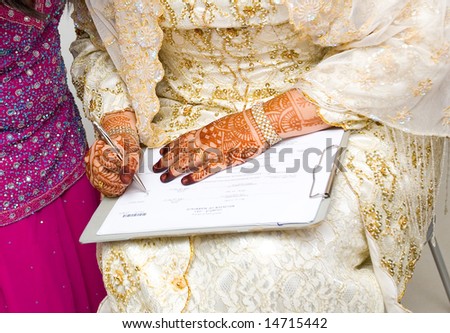 Muslim woman signing her marriage certificate.