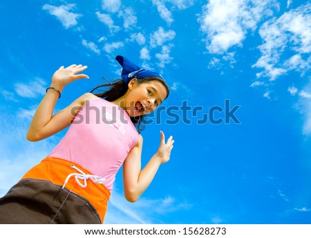 Young girl in swimming costume cheerful and happy with beautiful blue sky in  the background