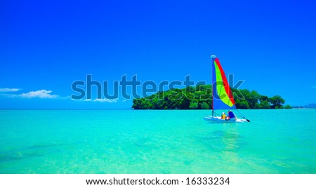 Family enjoying a ride in the sailboat at beautiful tropical sea