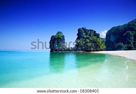stock photo : Tall cliffs with trees at Hong island surrounded by beautiful clear water of the Andaman sea.
