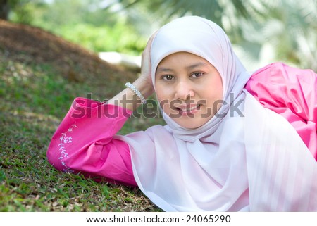 Beautiful Muslim Malay woman smiling in an outdoor park