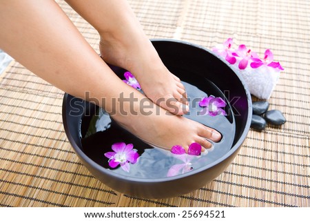 stock photo Feminine feet in oriental foot bath