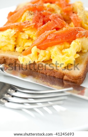 Breakfast of smoke salmon with scramble eggs on toast.