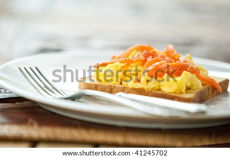 Toast with scrambled eggs and smoke salmon for breakfast