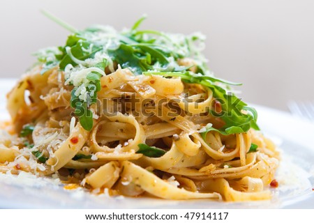 Delicious fettucine pasta with sundried tomato and rocket leaves