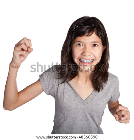 A very angry young girl with fist in air about to hit
