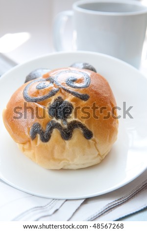 Freshly baked bun with funny bear face