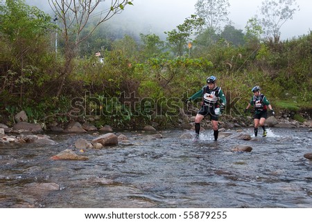 SABAH, MALAYSIA - APRIL 2: Participants wading through the river to get to destination within the race in the Sabah Adventure Challenge, April 2, 2010 in Sabah, Malaysia.
