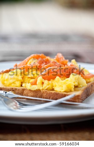 Smoke salmon with scrambled eggs on buttered toast