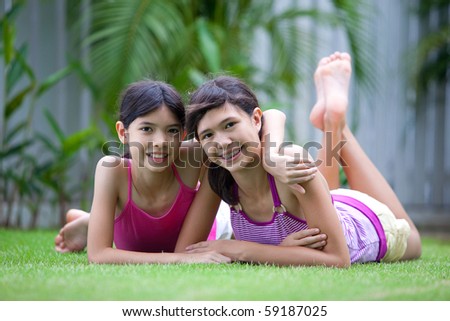 Two beautiful Chinese sisters in the outdoor garden
