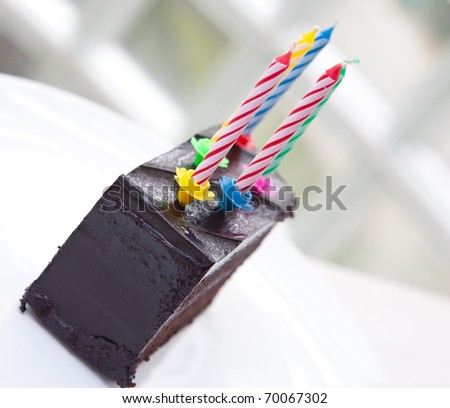 Delicious chocolate fudge cake with 5 colorful candles