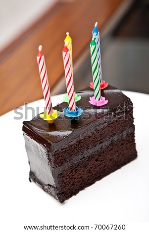 Delicious chocolate fudge cake with 5 colorful candles