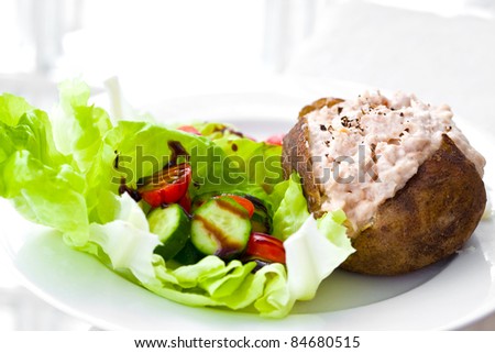 Freshly baked jacket potato with tuna mayonnaise and salad