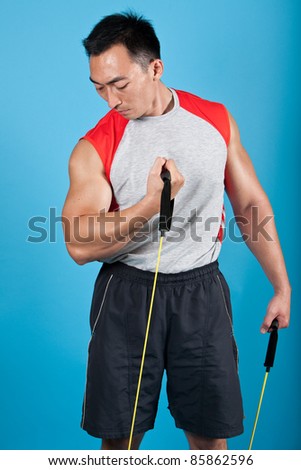 Young fit man with exercise stretch band