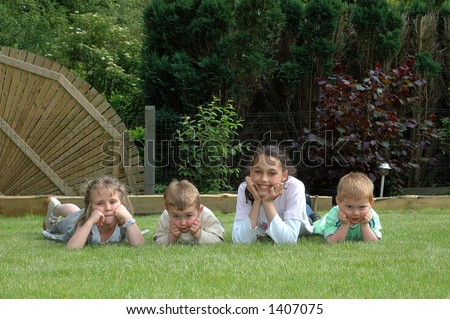 Toddlers and young girl in garden.  Youth concept.
