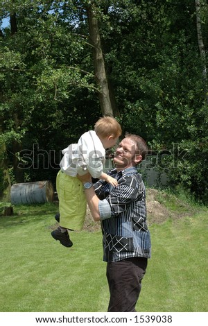 Father playing with son in the garden. Growth, generation concept.