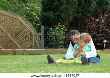 Toddler and young girl in garden.  Youth concept.