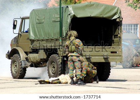military intervention.  soldier in action. War concept. War victim, injured soldier being rescued.