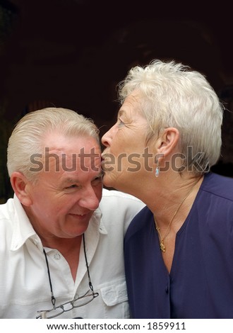 elderly couple, seniors still in love, woman kissing man. Love, romance, marriage concept.