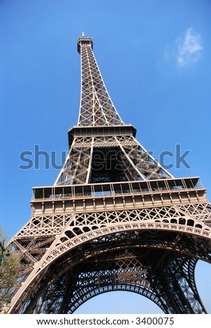 Paris, france, the eiffel tower against a vibrant blue spring sky.