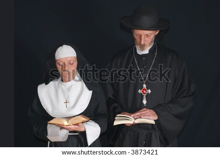 Middle aged devout nun and priest in deep thoughts, praying.  Religion, christianity, lifestyle concept