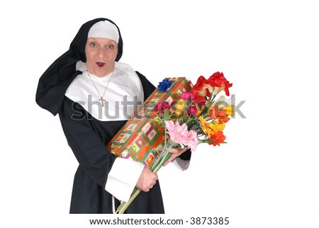Middle aged  sister, nun with birthday present and flowers.  Religion, christianity, lifestyle,  holiday concept