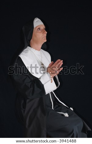 Middle aged devout nun in deep thoughts, praying.  Religion, christianity, lifestyle concept
