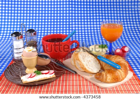 Breakfast, boiled egg, croissant and bread, butter, coffee and fruit juice  Food, nutrition, nourishment concept.