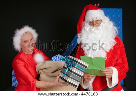 Xmas, Christmas time, santa claus and woman ready for delivering presents.  Holiday, happiness, peace concept.