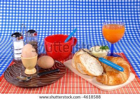 Breakfast, boiled egg, croissant and bread, butter, coffee and fruit juice  Food, nutrition, nourishment concept.